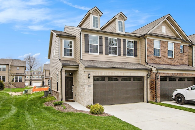 view of property with an attached garage, central AC, driveway, and a front yard