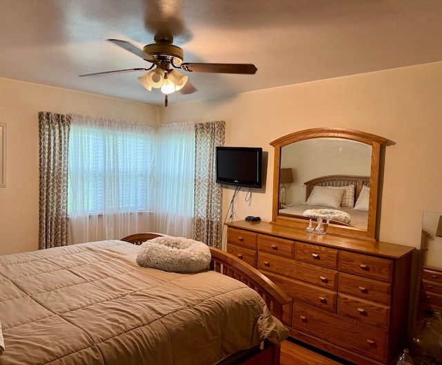 bedroom with ceiling fan and wood finished floors