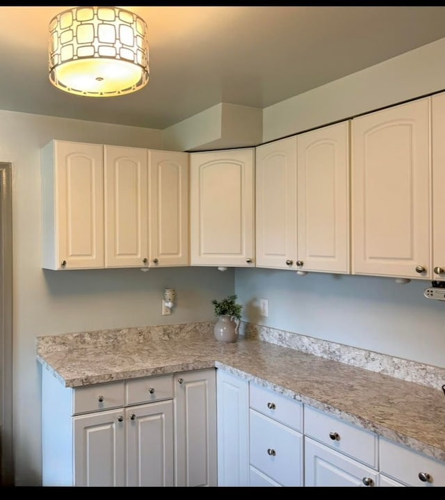 kitchen with light countertops and white cabinetry