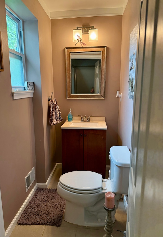 bathroom featuring vanity, baseboards, toilet, and visible vents