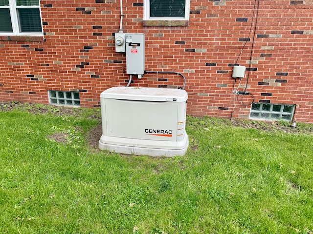 details featuring brick siding, a power unit, and electric meter