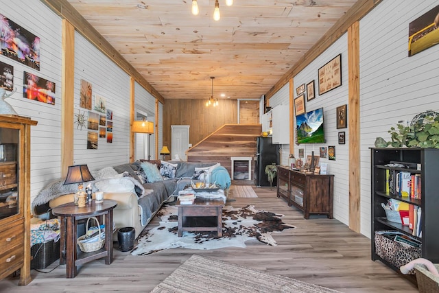living room with wood ceiling, wood finished floors, and wooden walls