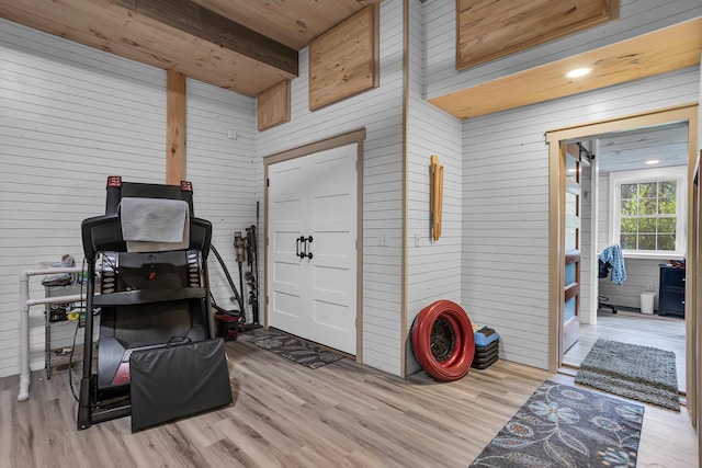 interior space with wooden walls and wood finished floors