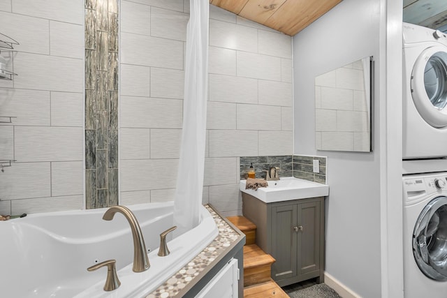 full bathroom featuring stacked washing maching and dryer and vanity