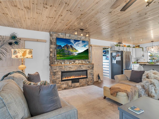 living room featuring wooden ceiling and a stone fireplace