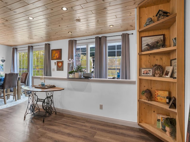 dining space featuring wood ceiling, baseboards, and wood finished floors