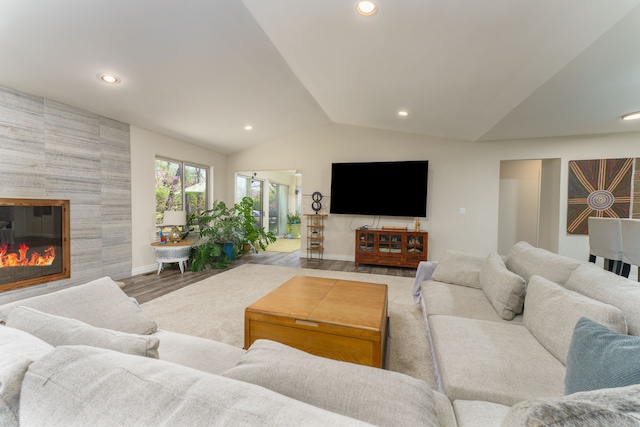 living area with recessed lighting, vaulted ceiling, wood finished floors, baseboards, and a tile fireplace