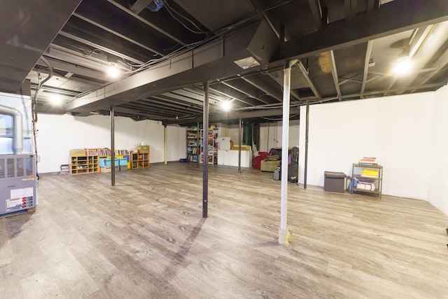 below grade area with wood finished floors and heating unit