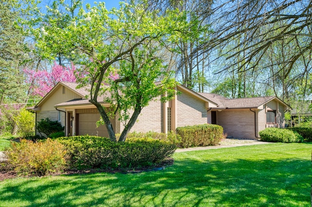 view of property exterior featuring brick siding, an attached garage, and a yard