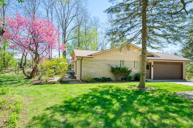 view of side of property featuring brick siding, a garage, a lawn, concrete driveway, and a shingled roof