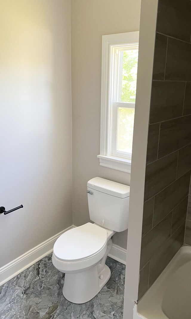 2439 Sheridan St, Detroit, MI 48214 - bathroom featuring toilet, baseboards, marble finish floor, and a shower