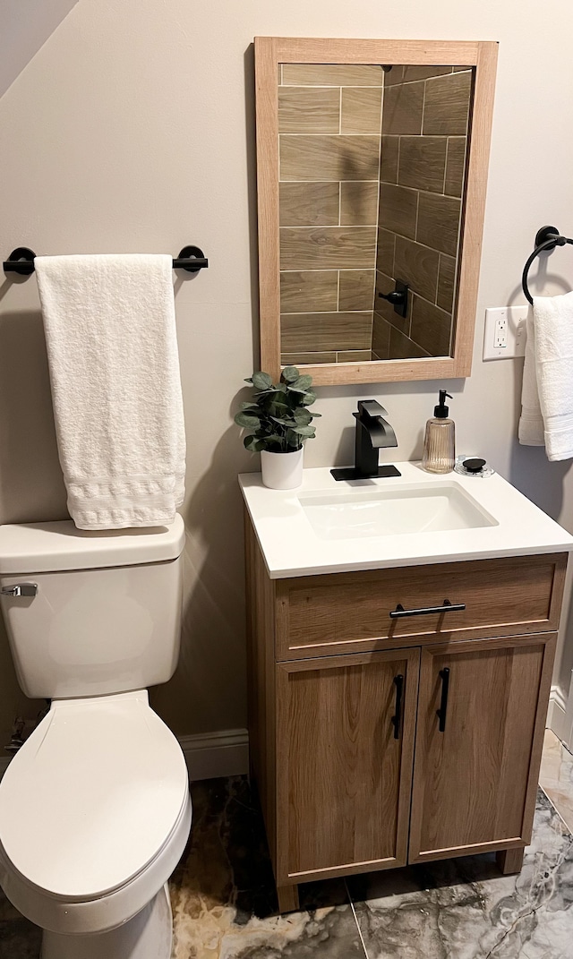 2439 Sheridan St, Detroit, MI 48214 - bathroom with toilet, baseboards, and vanity