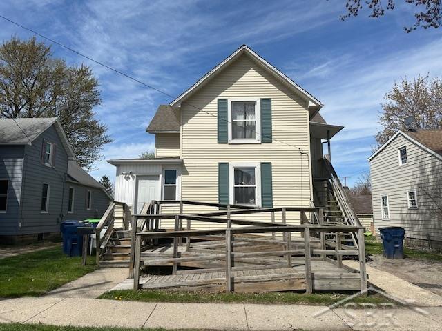 back of property with a wooden deck