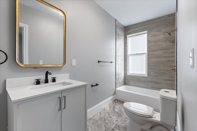bathroom featuring baseboards, vanity, toilet, marble finish floor, and tub / shower combination