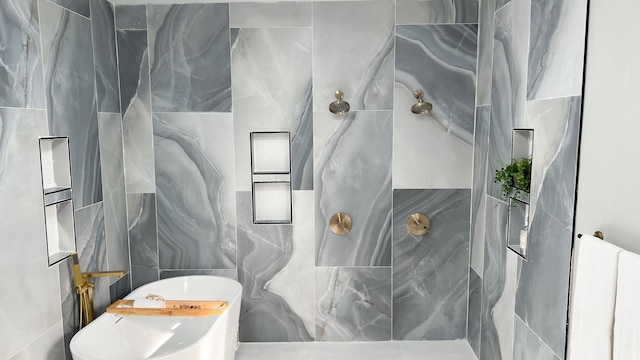 full bathroom with a freestanding bath, tile walls, and a marble finish shower