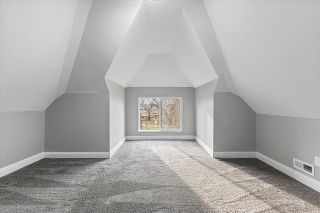 bonus room with carpet floors, baseboards, visible vents, and lofted ceiling