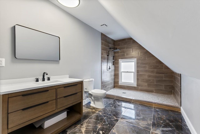 bathroom with toilet, tiled shower, marble finish floor, and vanity