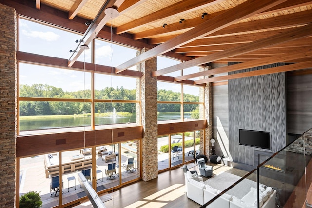 10463 W H Ave, Kalamazoo, MI 49009 - living area featuring a healthy amount of sunlight, high vaulted ceiling, beamed ceiling, and wood finished floors