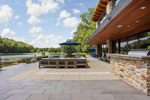 10463 W H Ave, Kalamazoo, MI 49009 - view of patio / terrace with a water view and an outdoor kitchen