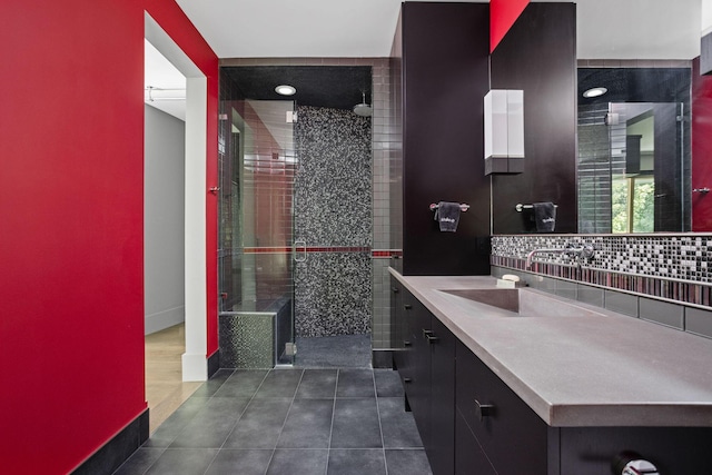 10463 W H Ave, Kalamazoo, MI 49009 - full bathroom with tile patterned flooring, tasteful backsplash, a stall shower, vanity, and baseboards