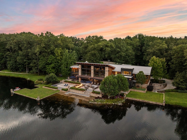 10463 W H Ave, Kalamazoo, MI 49009 - back of house featuring a lawn, a water view, metal roof, and a wooded view