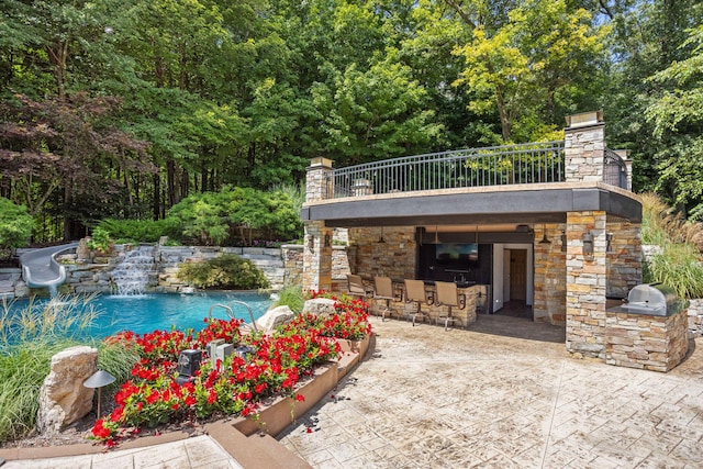 10463 W H Ave, Kalamazoo, MI 49009 - outdoor pool featuring an outdoor kitchen, an outdoor bar, a patio, and a water slide