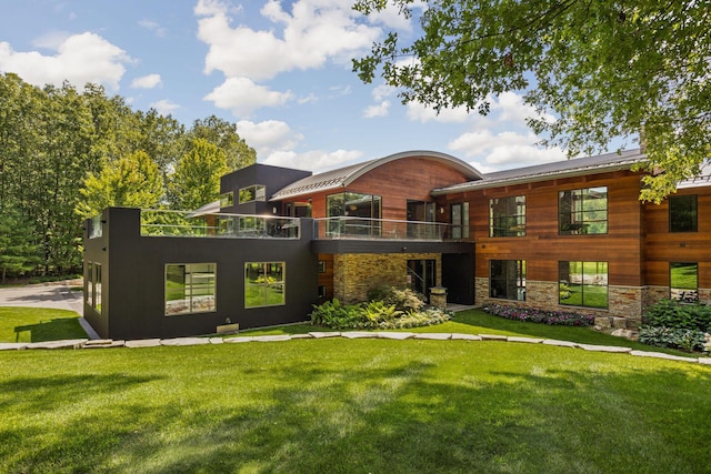 10463 W H Ave, Kalamazoo, MI 49009 - exterior space with stone siding, a balcony, and a front yard