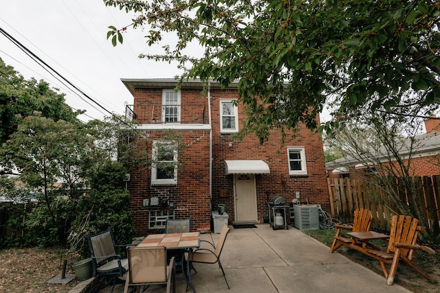 15261 Demean Ave, Allen Park, MI 48101 - rear view of house featuring brick siding, a patio area, fence, and cooling unit
