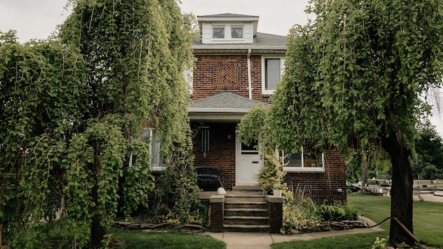 15261 Demean Ave, Allen Park, MI 48101 - view of front of house featuring brick siding, a shingled roof, and a front lawn