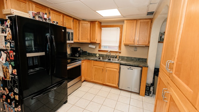 15261 Demean Ave, Allen Park, MI 48101 - kitchen with stainless steel appliances, a sink, dark countertops, a drop ceiling, and light tile patterned flooring