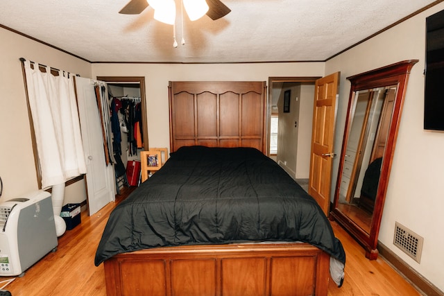 15261 Demean Ave, Allen Park, MI 48101 - bedroom with light wood-type flooring, a textured ceiling, ceiling fan, a closet, and baseboards