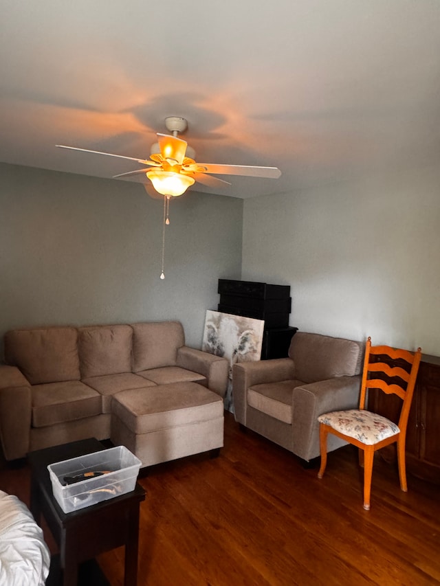 living room with a ceiling fan and dark wood-style floors