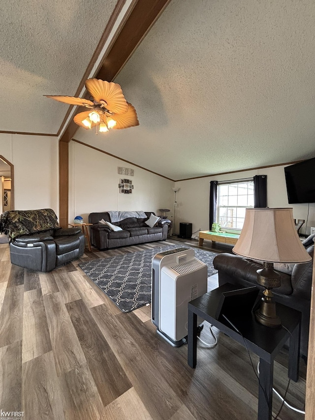living room featuring a ceiling fan, a textured ceiling, wood finished floors, and vaulted ceiling