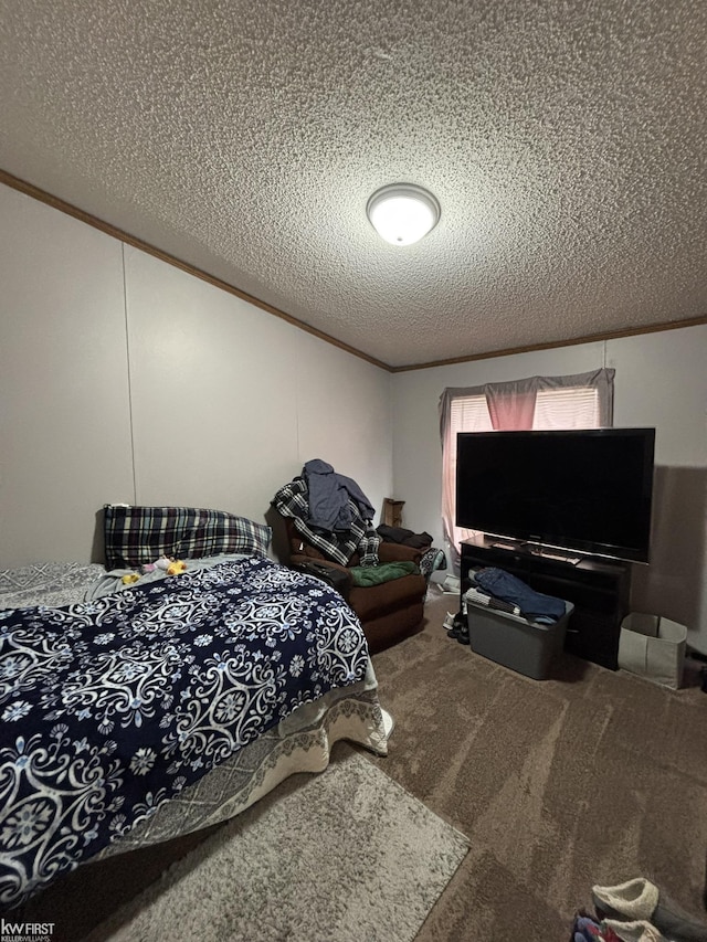 bedroom with crown molding, a textured ceiling, and carpet floors