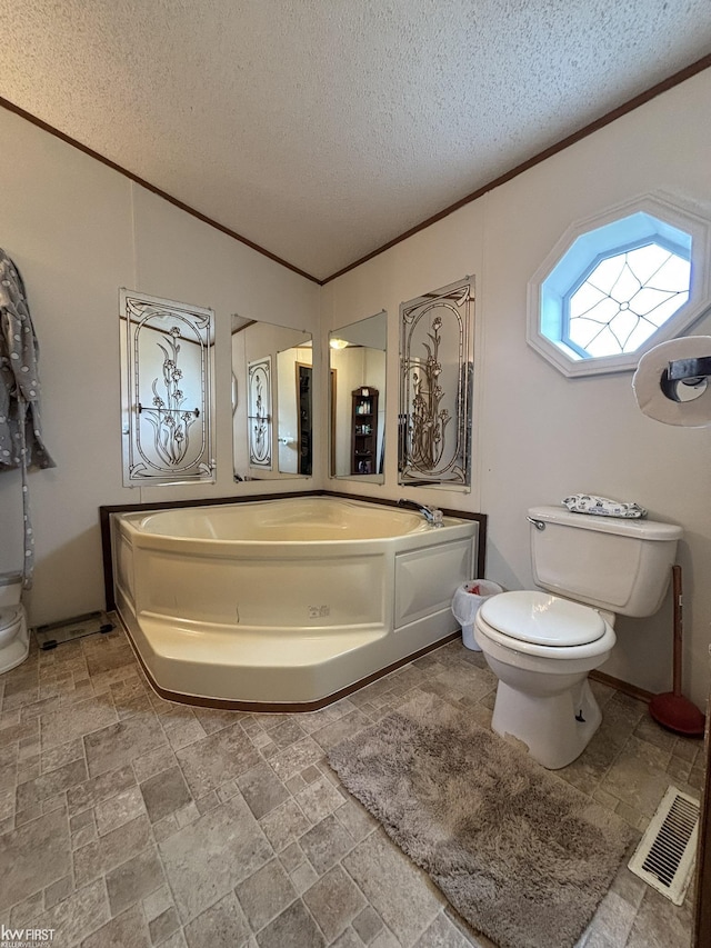 bathroom featuring visible vents, a textured ceiling, crown molding, and toilet