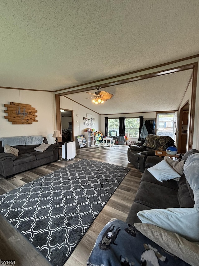 living room featuring a ceiling fan, a textured ceiling, and wood finished floors