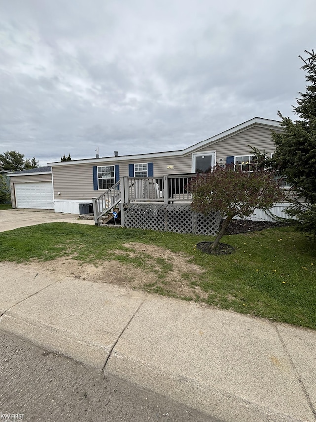manufactured / mobile home with central AC, a front yard, and a garage