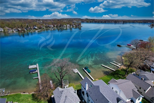 drone / aerial view featuring a water view and a residential view