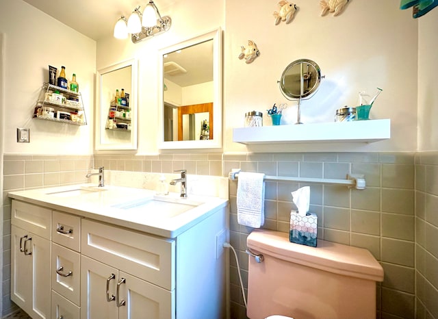 9186 Arnold St, Redford, MI 48239 - full bath with tile walls, toilet, a wainscoted wall, and double vanity