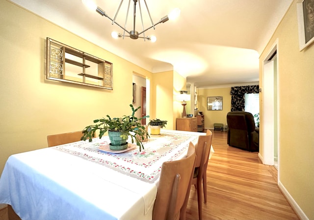 9186 Arnold St, Redford, MI 48239 - dining room with a chandelier, light wood-style floors, and baseboards