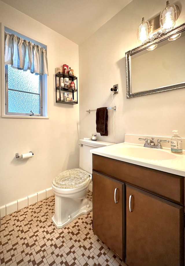 9186 Arnold St, Redford, MI 48239 - half bathroom with toilet, vanity, tile patterned floors, and baseboards