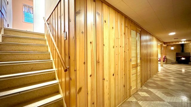 9186 Arnold St, Redford, MI 48239 - corridor with wood walls, stairway, and tile patterned floors