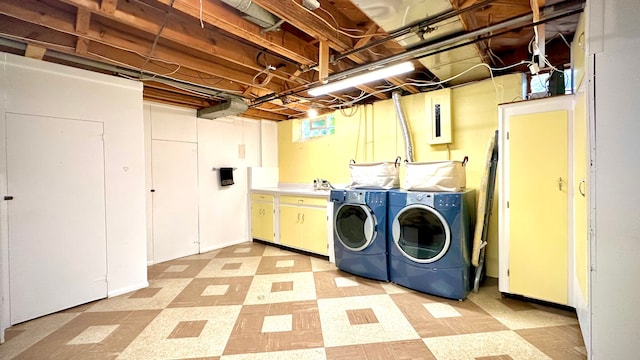 9186 Arnold St, Redford, MI 48239 - laundry area featuring washing machine and clothes dryer, light flooring, and cabinet space