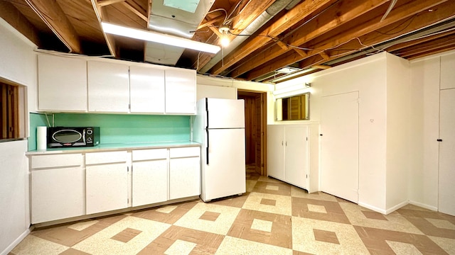 9186 Arnold St, Redford, MI 48239 - kitchen featuring freestanding refrigerator, light flooring, light countertops, and white cabinetry