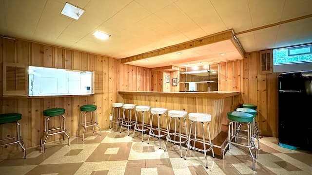 9186 Arnold St, Redford, MI 48239 - indoor dry bar with wooden walls and tile patterned floors