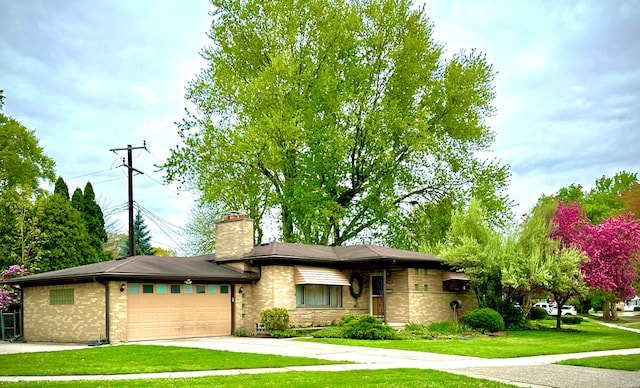 9186 Arnold St, Redford, MI 48239 - prairie-style home with a front yard, an attached garage, a chimney, concrete driveway, and brick siding