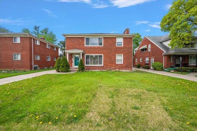 2180 Vernier Rd, Grosse Pointe Woods, MI 48236 - view of front of property with a front lawn, brick siding, and a chimney