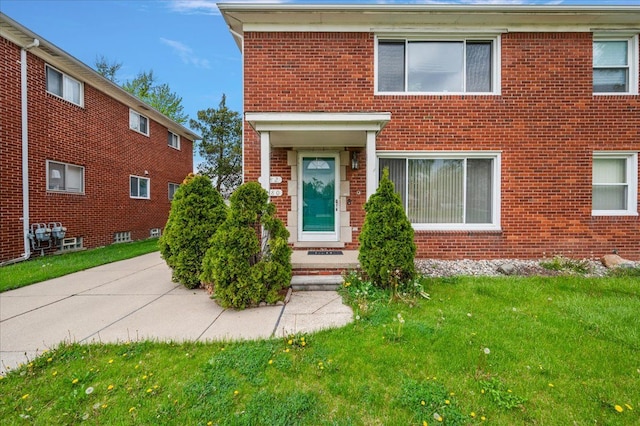 2180 Vernier Rd, Grosse Pointe Woods, MI 48236 - view of front of home featuring brick siding and a front lawn