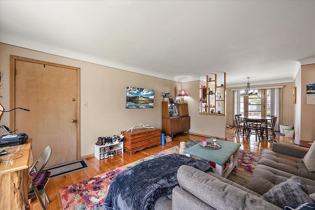 2180 Vernier Rd, Grosse Pointe Woods, MI 48236 - living room with baseboards, a notable chandelier, and light wood-type flooring