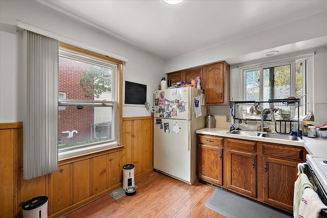 2180 Vernier Rd, Grosse Pointe Woods, MI 48236 - kitchen featuring a sink, freestanding refrigerator, a healthy amount of sunlight, and light wood finished floors